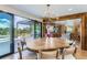 Elegant dining room with a unique, circular table, chandelier, and a view to the backyard at 6709 Walker Ct, Niwot, CO 80503