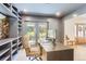 Bright office with a modern desk, built-in shelves, and access to a private outdoor space at 6709 Walker Ct, Niwot, CO 80503