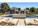 Beautiful outdoor pool area with a patio, a fire feature, a hot tub, and lounge furniture at 6709 Walker Ct, Niwot, CO 80503