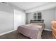 Bedroom featuring a large bed, wooden dresser, and plenty of natural light at 10211 Ura Ln # 8-102, Thornton, CO 80260