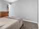 Bedroom featuring a large bed, carpet, and plenty of natural light at 10211 Ura Ln # 8-102, Thornton, CO 80260