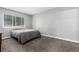 Cozy bedroom with neutral carpet, a comfortable bed, and large window at 10211 Ura Ln # 8-102, Thornton, CO 80260