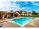 A bright blue community pool is set amongst lawn chairs and complex buildings at 10211 Ura Ln # 8-102, Thornton, CO 80260
