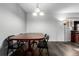 Dining area with a wooden table and chairs, hardwood floors, and natural lighting from the window at 10211 Ura Ln # 8-102, Thornton, CO 80260