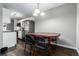 Dining area with a dark wood table and stainless steel refrigerator, with hardwood floors at 10211 Ura Ln # 8-102, Thornton, CO 80260