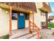 The front entrance has a blue door, orange trim, and a warning sign above the door at 10211 Ura Ln # 8-102, Thornton, CO 80260
