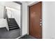 View of front door, staircase and hallway outside of apartment 102 at 10211 Ura Ln # 8-102, Thornton, CO 80260