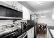 Kitchen features stainless steel appliances, white subway tile, and dark granite countertops at 10211 Ura Ln # 8-102, Thornton, CO 80260