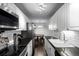 Modern kitchen featuring stainless steel appliances, white cabinets, and dark countertops at 10211 Ura Ln # 8-102, Thornton, CO 80260