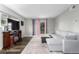 Bright living room with a gray sectional couch, fireplace, and sliding glass doors to the outside at 10211 Ura Ln # 8-102, Thornton, CO 80260