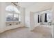 Airy bedroom with a large arched window, built-in shelving, and a neutral color scheme at 5885 W Atlantic Pl, Lakewood, CO 80227