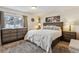 Cozy bedroom featuring warm tones, soft textures, and a comfortable queen-sized bed with stylish furnishings at 5885 W Atlantic Pl, Lakewood, CO 80227