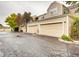 Two-story home featuring tan siding, peaked roof lines, and individual garages at 5885 W Atlantic Pl, Lakewood, CO 80227