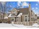 Two-story townhome, rear view, snow-covered yard at 5885 W Atlantic Pl, Lakewood, CO 80227