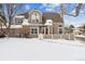 Two-story townhome with snow-covered front yard at 5885 W Atlantic Pl, Lakewood, CO 80227