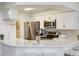 Modern kitchen with white cabinets and gold accents at 5885 W Atlantic Pl, Lakewood, CO 80227