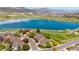 Beautiful aerial view of a home in a neighborhood near a lake, mountains, and open space at 12421 W Fair Dr, Littleton, CO 80127