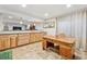 Finished basement with a large wet bar, tile flooring and an ornate desk at 12421 W Fair Dr, Littleton, CO 80127