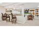 Finished basement with a wet bar, stools, and plenty of recreational space at 12421 W Fair Dr, Littleton, CO 80127
