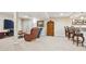 Spacious finished basement with bar, seating area, tv and vintage cabinet at 12421 W Fair Dr, Littleton, CO 80127