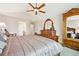 This bedroom boasts a large wardrobe, dresser with a mirror, and elegant furnishings at 12421 W Fair Dr, Littleton, CO 80127