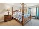 Bedroom with four poster bed, side table, and view of the outside at 12421 W Fair Dr, Littleton, CO 80127