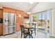 Bright dining area with stainless steel refrigerator and sliding doors that open to backyard at 12421 W Fair Dr, Littleton, CO 80127