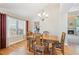 Cozy dining area featuring a chandelier and an open view of the fireplace at 12421 W Fair Dr, Littleton, CO 80127