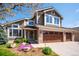Beautiful two-story home featuring a three car garage and manicured lawn at 12421 W Fair Dr, Littleton, CO 80127