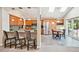 Eat-in kitchen boasts stainless steel appliances, granite countertops, breakfast bar, and adjacent dining area with abundant natural light at 12421 W Fair Dr, Littleton, CO 80127