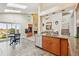 Bright eat-in kitchen showcasing granite counters, stainless appliances, and seamless transition to living and dining areas at 12421 W Fair Dr, Littleton, CO 80127