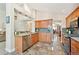 Modern kitchen with stainless steel appliances, granite counters, and seamless transition to the open-concept living space at 12421 W Fair Dr, Littleton, CO 80127