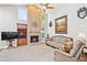 Bright living room features a beautiful fireplace and cozy seating at 12421 W Fair Dr, Littleton, CO 80127