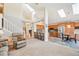 Spacious living room features skylights, an open floor plan, and seamlessly connects to a modern kitchen and staircase at 12421 W Fair Dr, Littleton, CO 80127