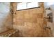 Tiled walk-in shower with bench, a shower wand, and multiple water outlets at 12421 W Fair Dr, Littleton, CO 80127