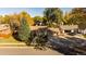 Housetop view with driveway and autumn trees at 11177 W 68Th Pl, Arvada, CO 80004