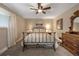 Comfortable bedroom with ceiling fan and antique dresser at 11177 W 68Th Pl, Arvada, CO 80004