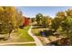 Scenic walking path winds through a tree-lined community with colorful autumn foliage at 11177 W 68Th Pl, Arvada, CO 80004