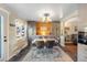 Bright dining room with wood-paneled accent wall and vintage-style table at 11177 W 68Th Pl, Arvada, CO 80004