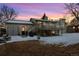 House back view with deck, snowy yard and twilight at 11177 W 68Th Pl, Arvada, CO 80004