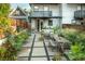 Beautiful backyard featuring stone pavers, lush landscaping, and patio seating at 3168 W 29Th Ave, Denver, CO 80211