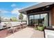 Cozy balcony with outdoor seating, a small table, greenery, and sliding glass doors at 3168 W 29Th Ave, Denver, CO 80211