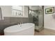 Bathroom offers a freestanding tub, separate glass shower, and a window for natural light at 3168 W 29Th Ave, Denver, CO 80211