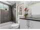 Charming bathroom featuring gray tile and shower-tub combination at 3168 W 29Th Ave, Denver, CO 80211