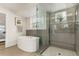 Bright bathroom featuring a glass shower and a soaking tub with modern fixtures and decor at 3168 W 29Th Ave, Denver, CO 80211