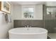 Bathroom showcasing a soaking tub with sleek tile accents, and modern finishes at 3168 W 29Th Ave, Denver, CO 80211