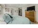 Bedroom featuring a cozy bed, a dresser with a TV, and doorways leading to other rooms at 3168 W 29Th Ave, Denver, CO 80211