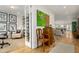 Hallway leading to a living room featuring hardwood floors and decorative artwork at 3168 W 29Th Ave, Denver, CO 80211