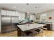 Contemporary kitchen with a center island, modern appliances, and hardwood flooring at 3168 W 29Th Ave, Denver, CO 80211
