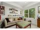 Inviting living room with large windows, a comfortable sofa, and decorative shelving at 3168 W 29Th Ave, Denver, CO 80211